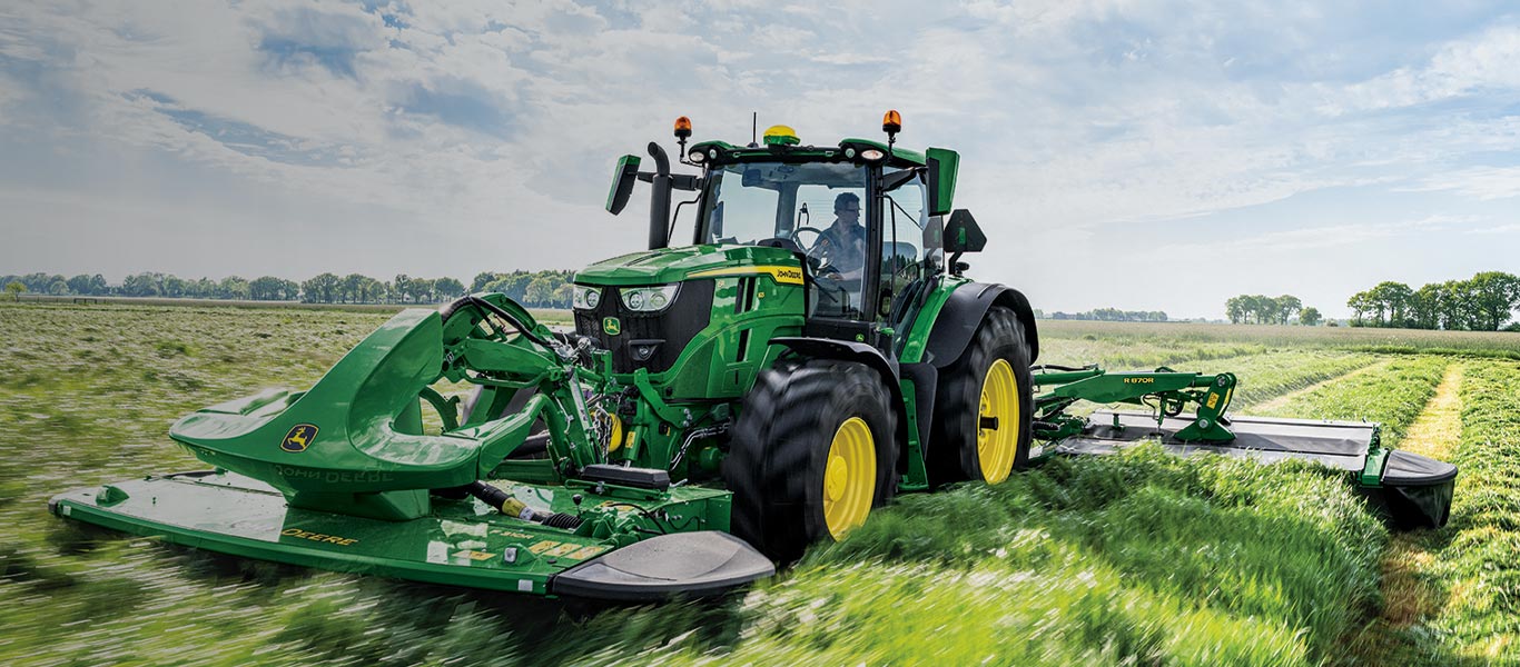 6r tractor in field of long grass