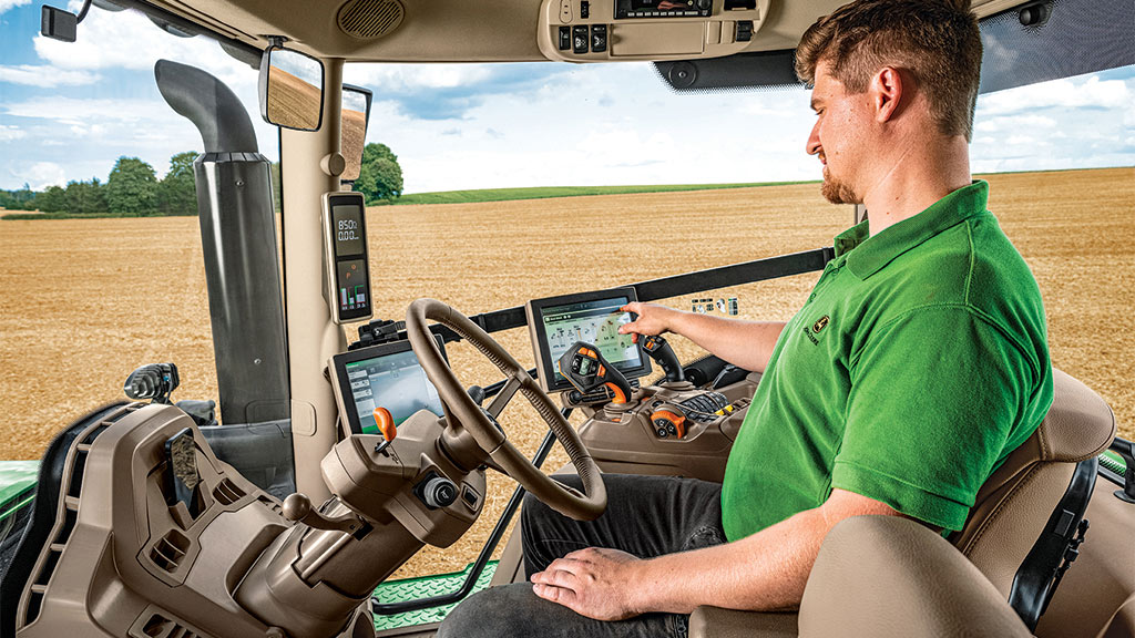 person driving tractor in field