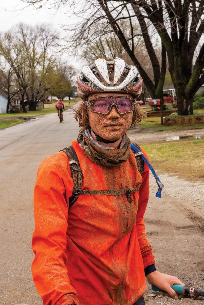 Cyclist with muddy goggles and face