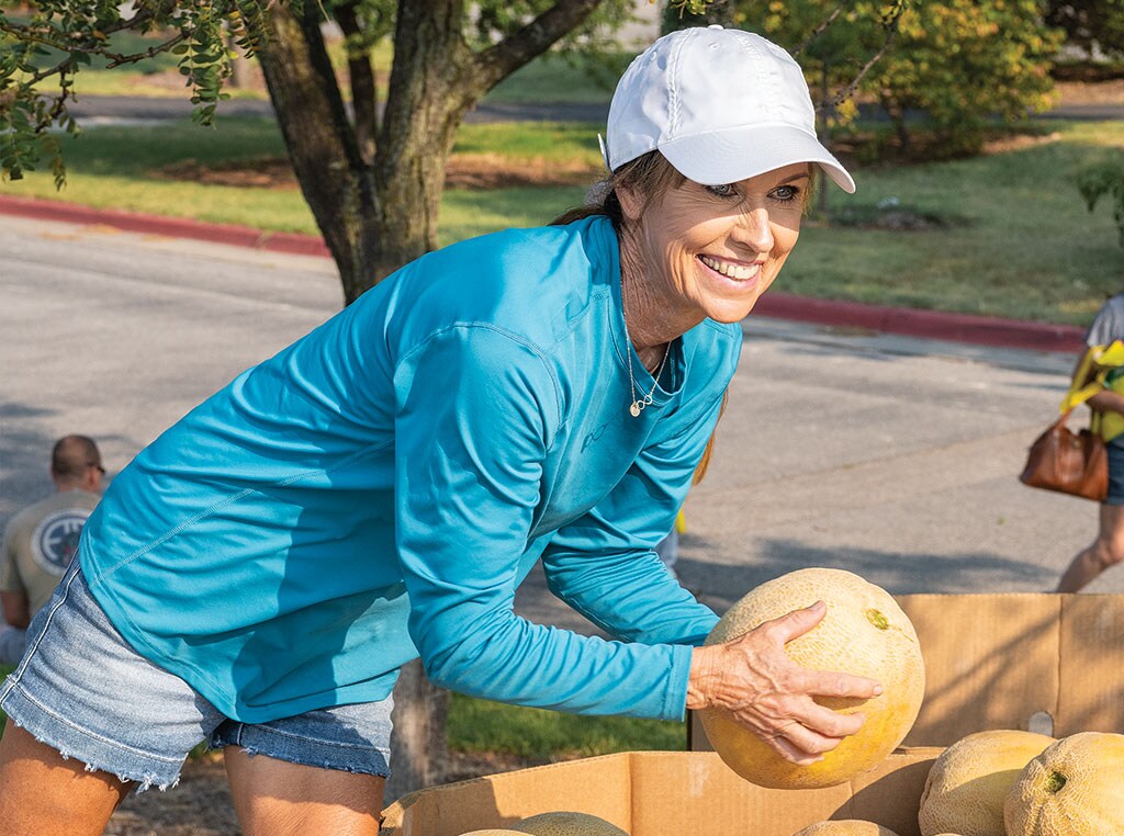 woman holding a melon