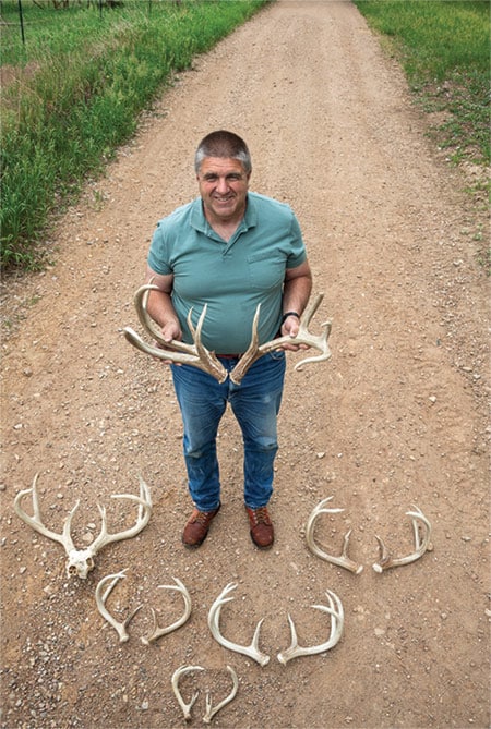 Hayes standing holding antlers