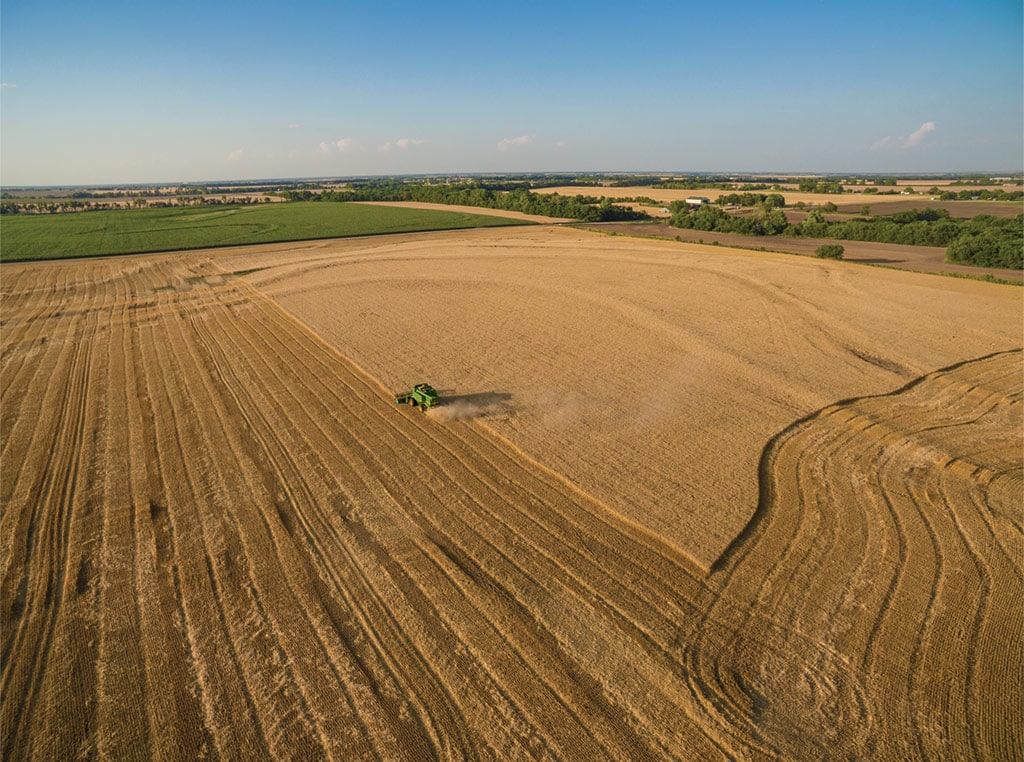 John Deere Combine in field from a distance photo