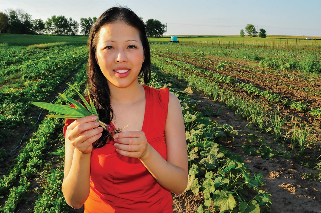 Mhonpaj Lee posed with traditional Hmong herbs in Minnesota.