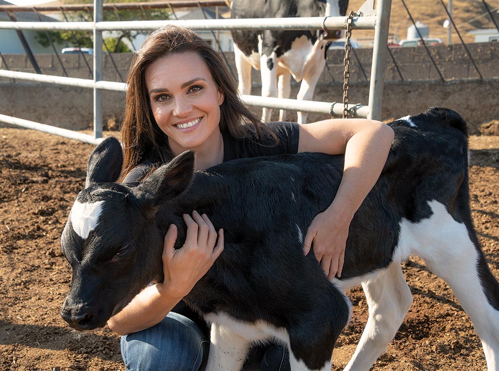 woman with hugging a calve