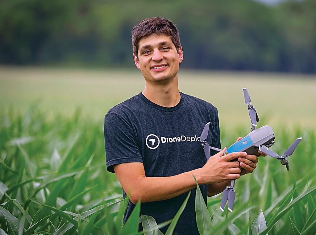 Man standing holding a drone