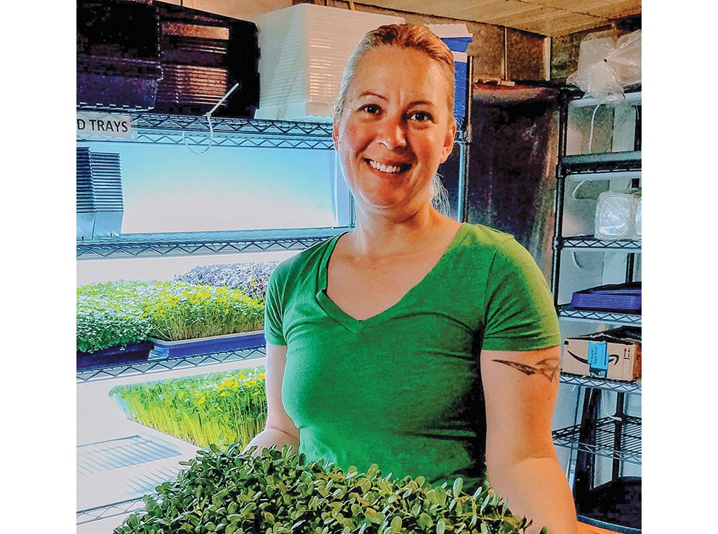 woman holding micogreen plants