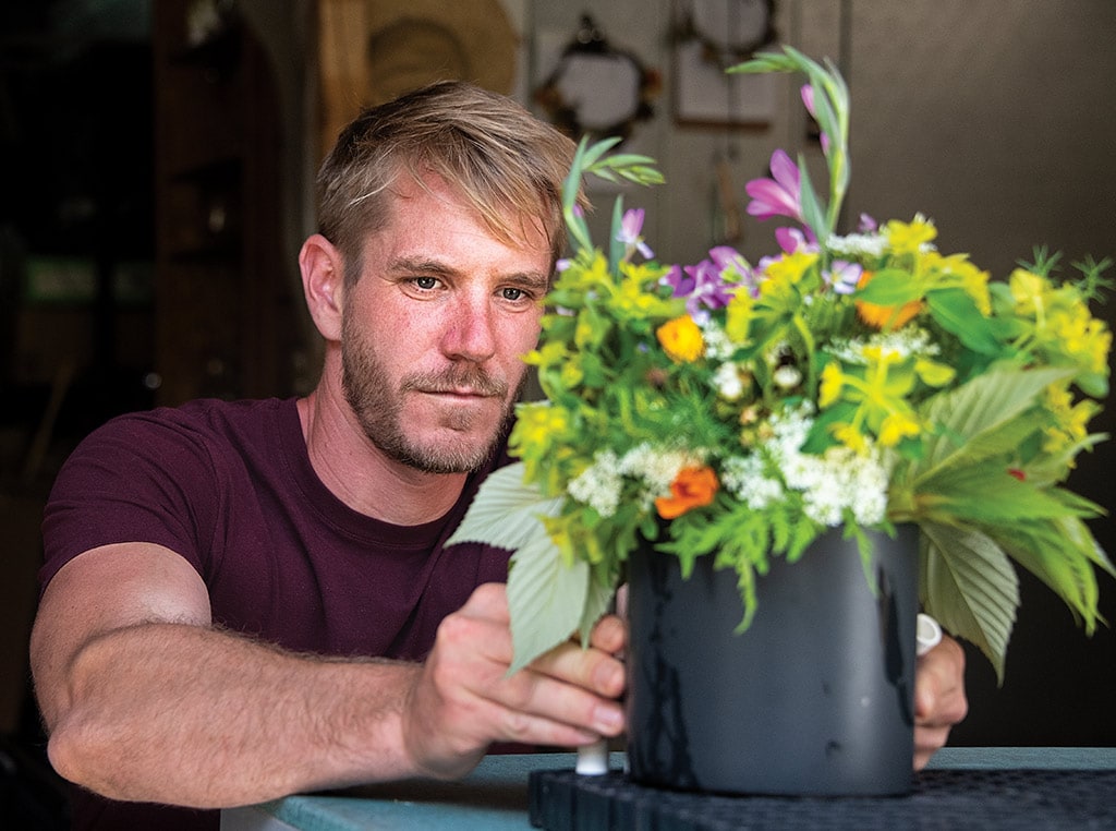 person arranging flowers