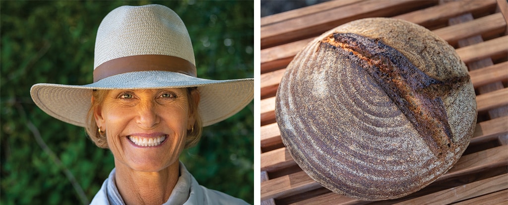 woman with hit smiling and loaf of bread closeup