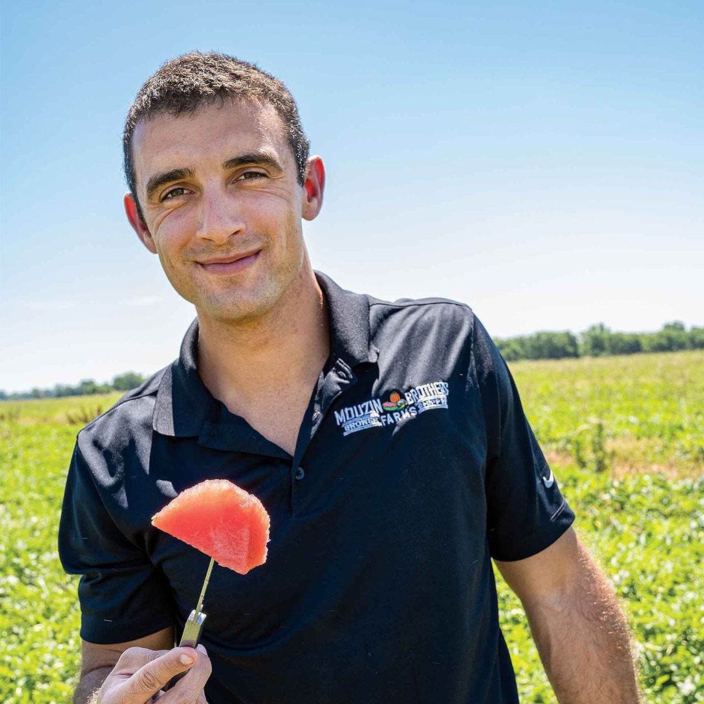 man with piece of watermelon on a knife