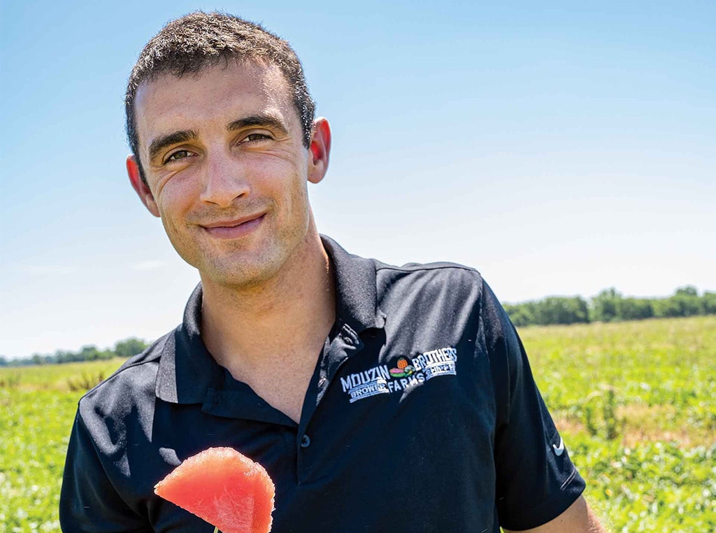 man with piece of watermelon on a knife