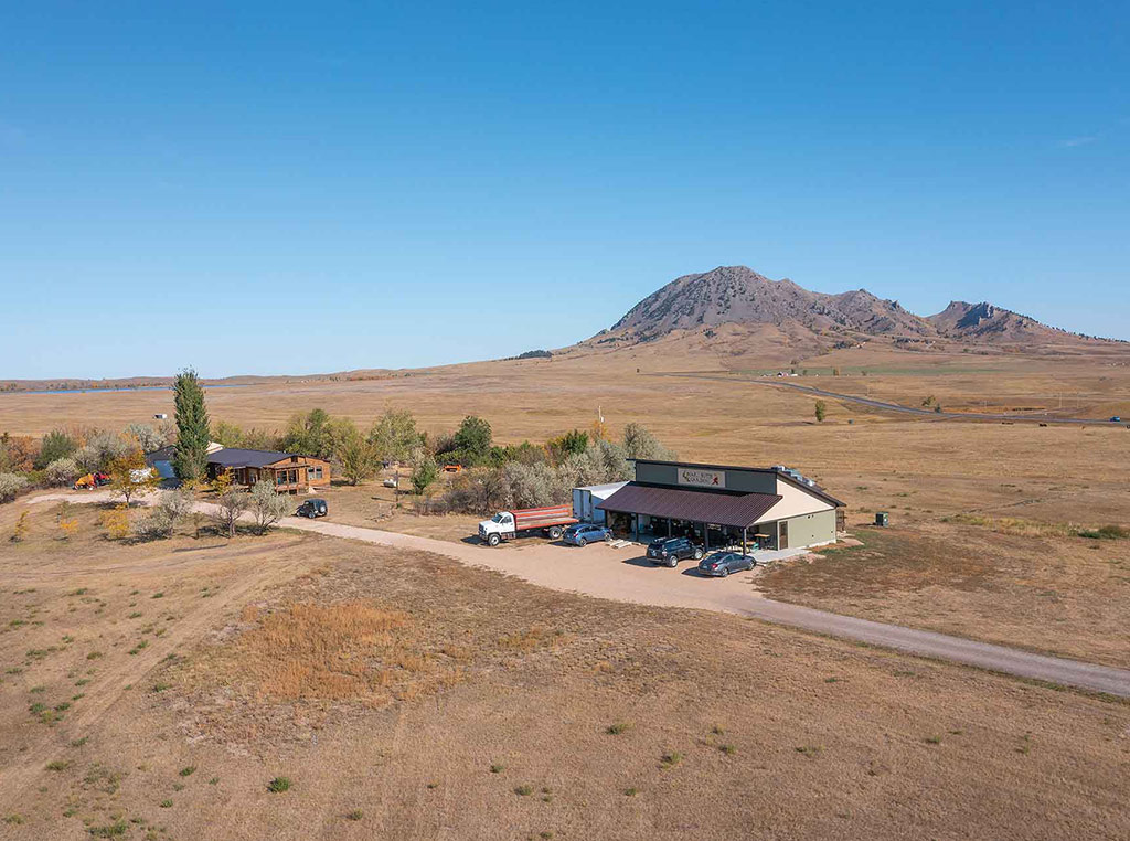 farm store in dry valley below single distant mountain
