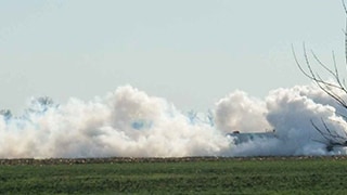 plumes of steam emanating from the ground on the horizon