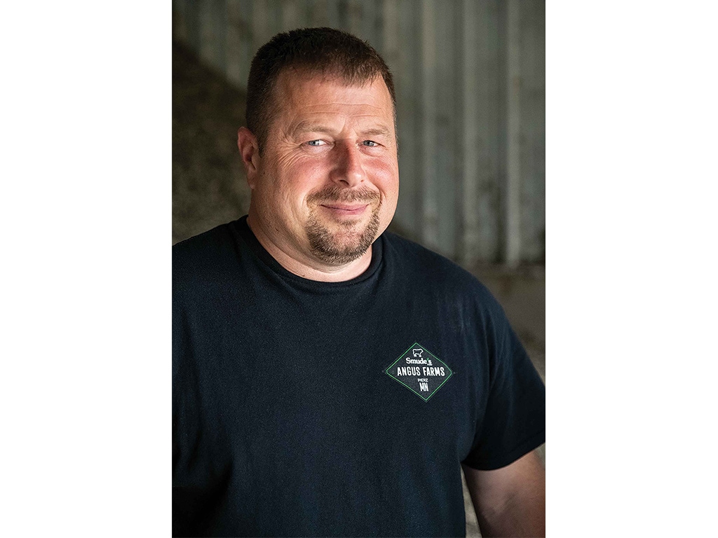 Man smiling with a black tee shirt on