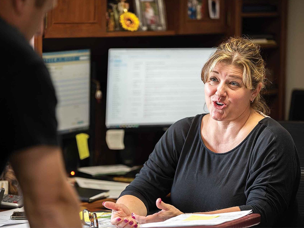 woman at an office desk speaking