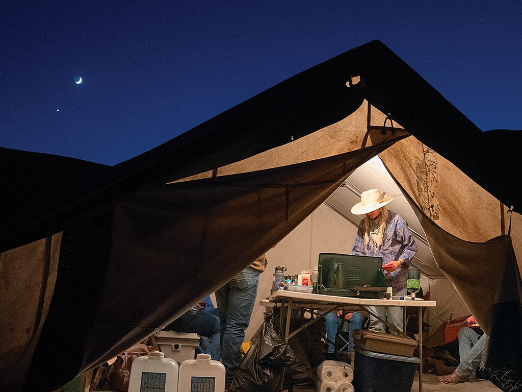 people standing in a tent with supplies