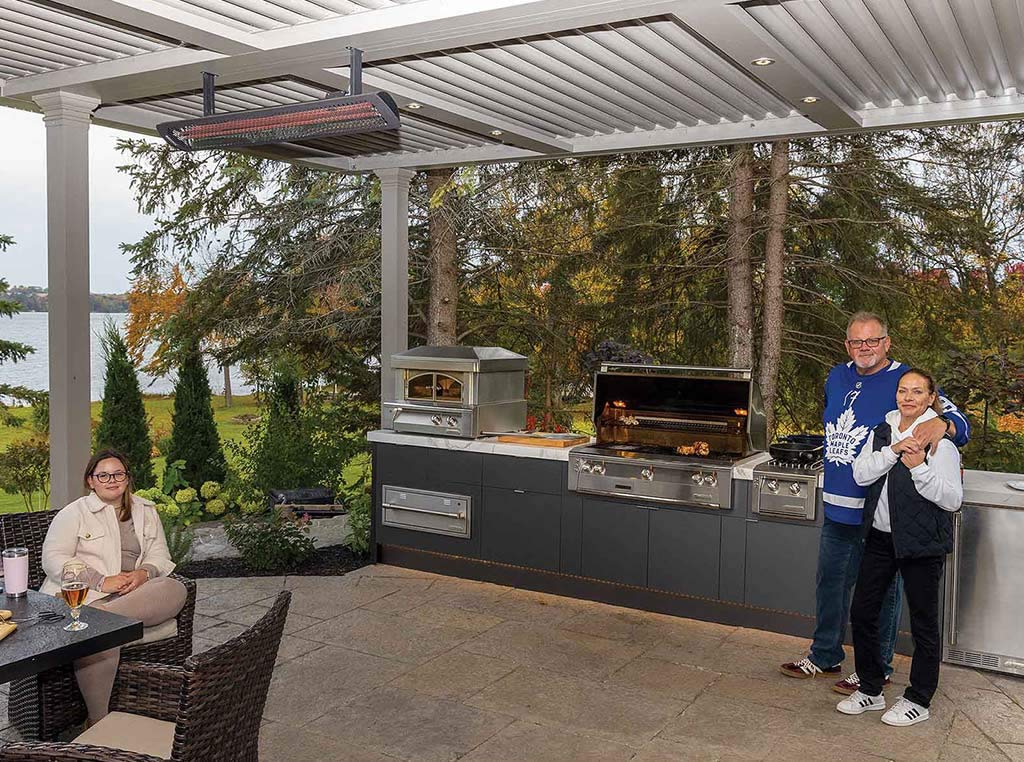 people standing and sitting in an outdoor kitchen