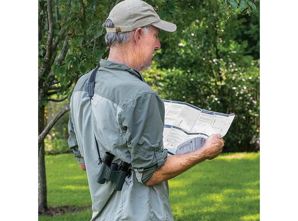 man standing and studying a map