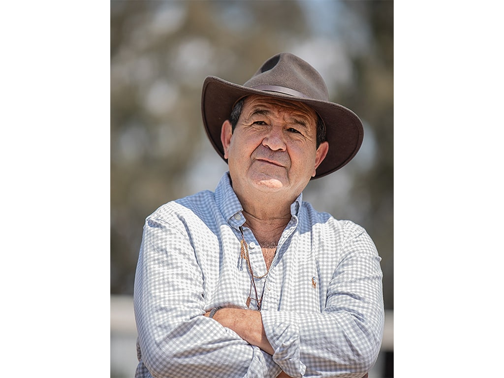 farmer with brown hat and checkered shirt posing