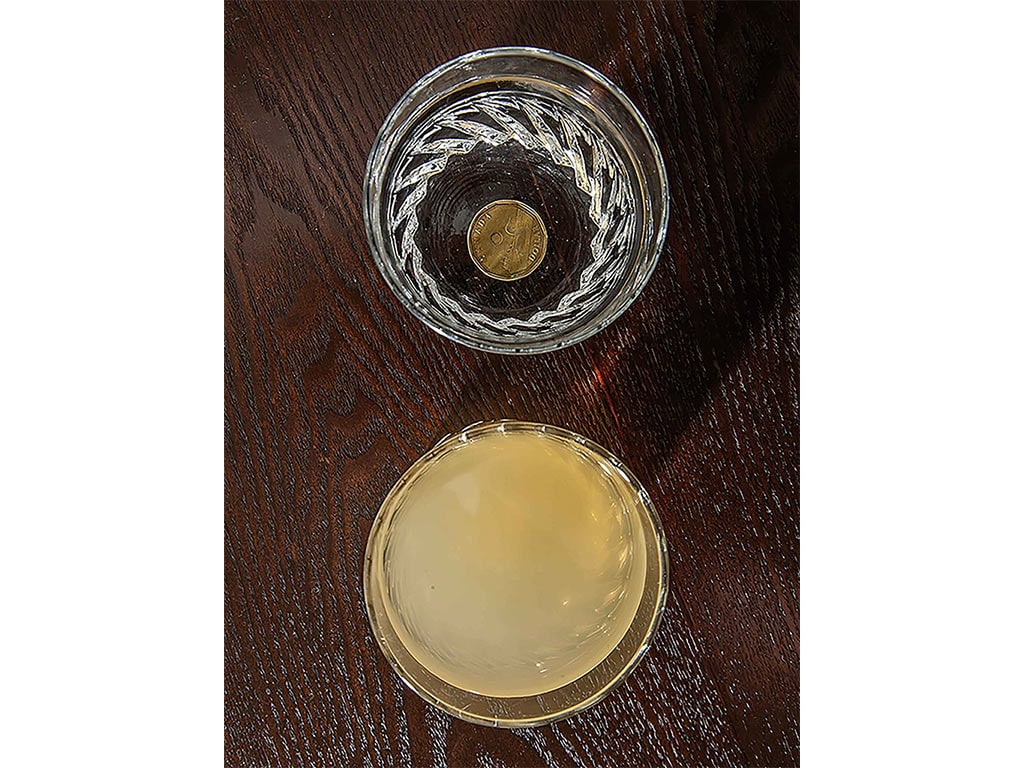 two glasses of water from above, one of which is cloudy and yellow
