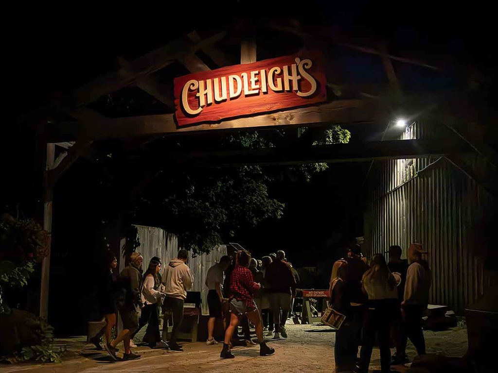 A group of concert-goers entering the music venue at Chudleigh's orchard
