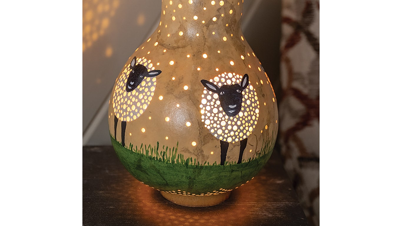 Illuminated gourd lantern painted with sheep.