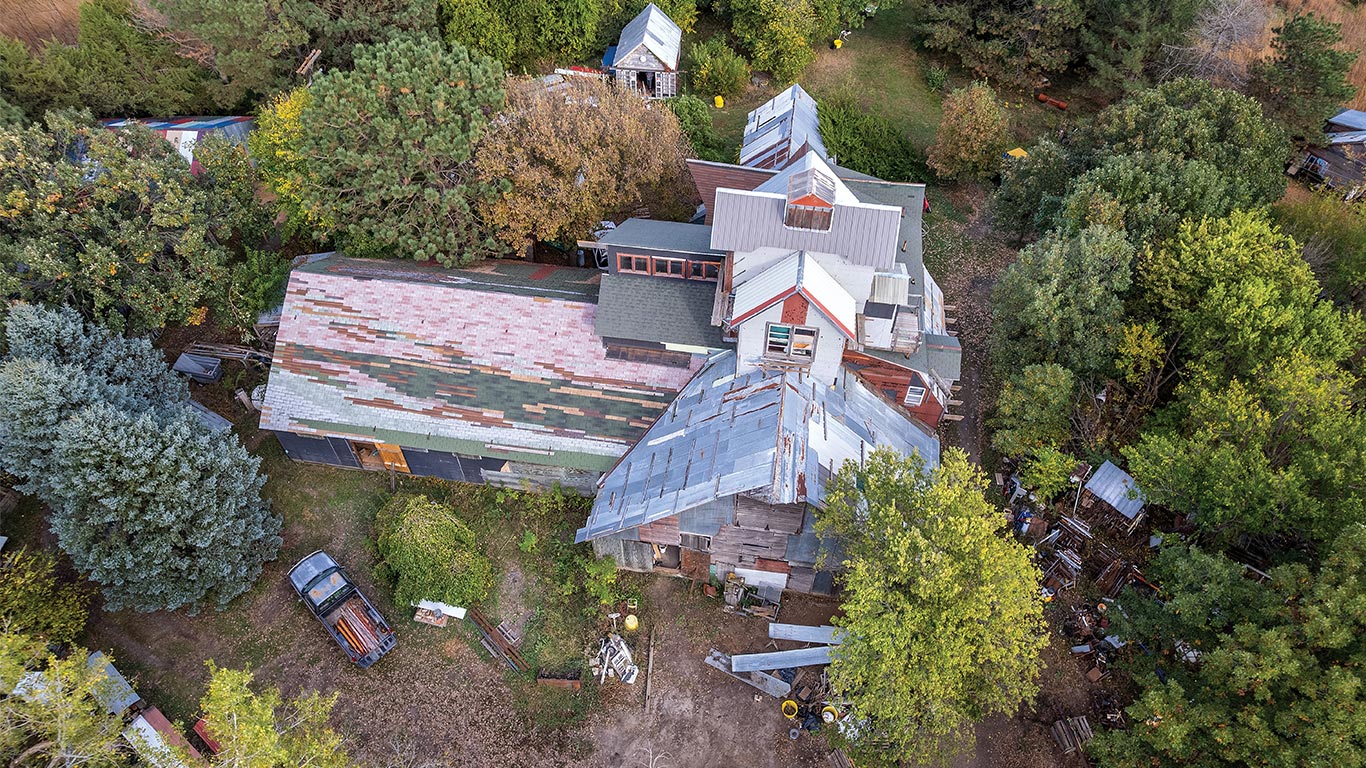 A victorian home with several different colored walls and roof tiles.