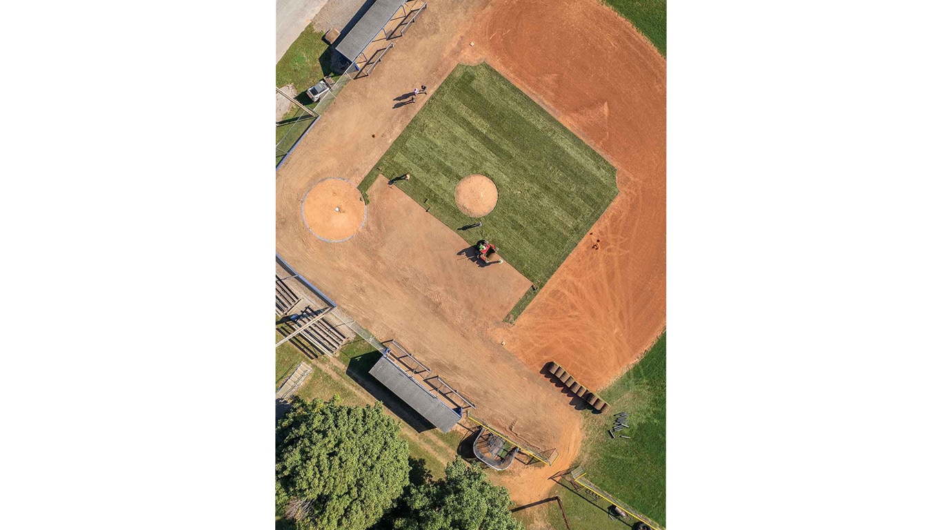 Aerial view of a baseball field with sod installation in progress.